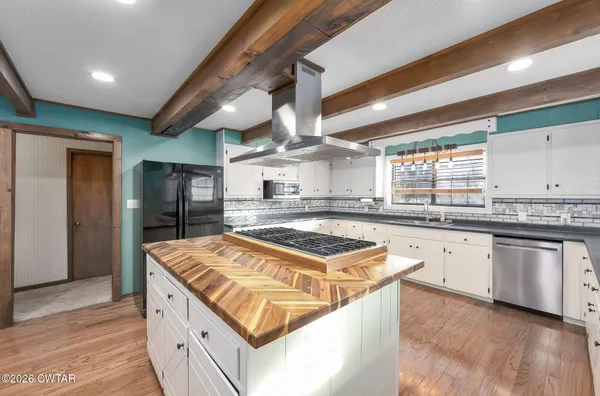 a kitchen with stainless steel appliances granite countertop a stove and a sink