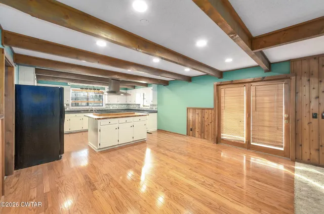 a bathroom with a sink shower and a mirror