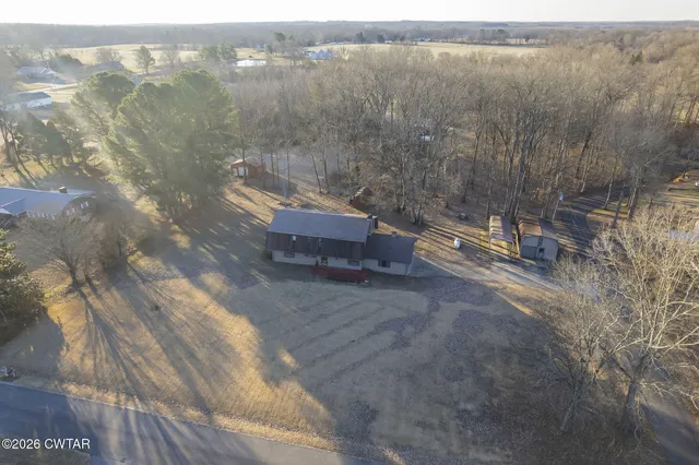 a view of a house with a large tree and a big yard