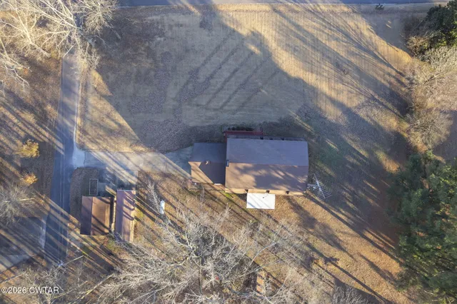 a view of a house with a yard and a garage