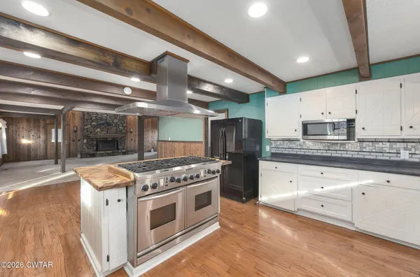 a kitchen with stainless steel appliances granite countertop a stove and a refrigerator