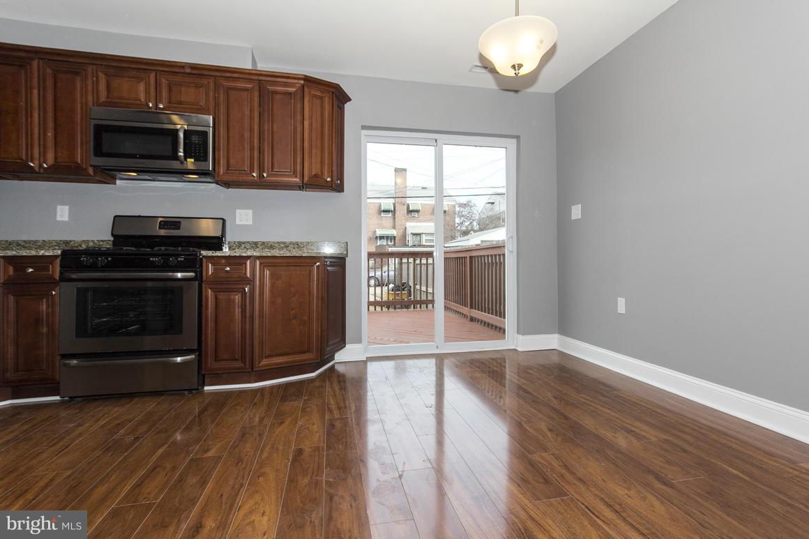 33 Eastship Road Baltimore, MD 21222 - Photo 2 of 23 a kitchen with granite countertop wooden floors and stainless steel appliances