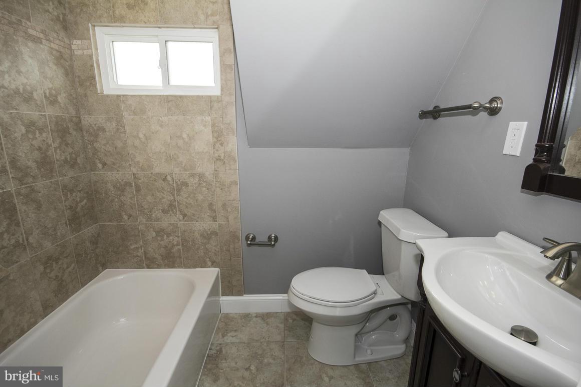 33 Eastship Road Baltimore, MD 21222 - Photo 17 of 23 a white toilet sitting next to a bath tub