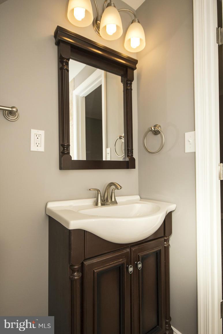 33 Eastship Road Baltimore, MD 21222 - Photo 18 of 23 a bathroom with a sink and a mirror