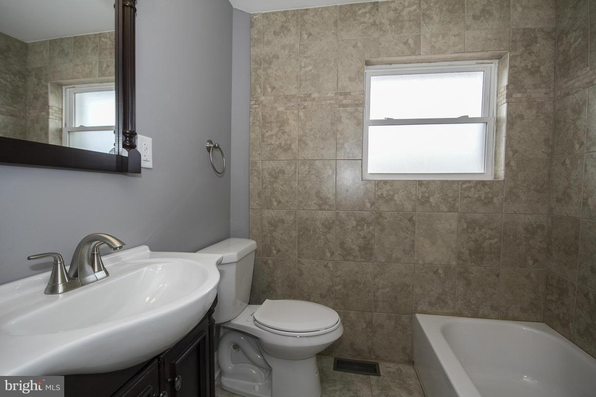 33 Eastship Road Baltimore, MD 21222 - Photo 8 of 23 a bathroom with a sink a toilet and a bathtub