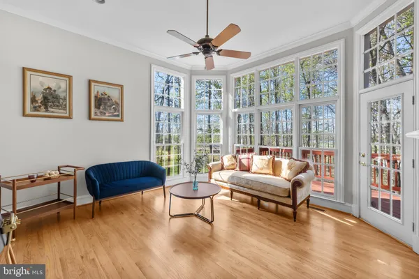 a open kitchen with stainless steel appliances granite countertop a stove top oven a sink dishwasher a dining table and chairs with wooden floor