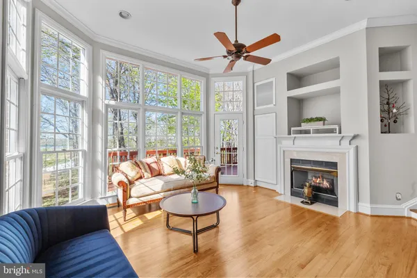 a living room filled with furniture and floor to ceiling windows