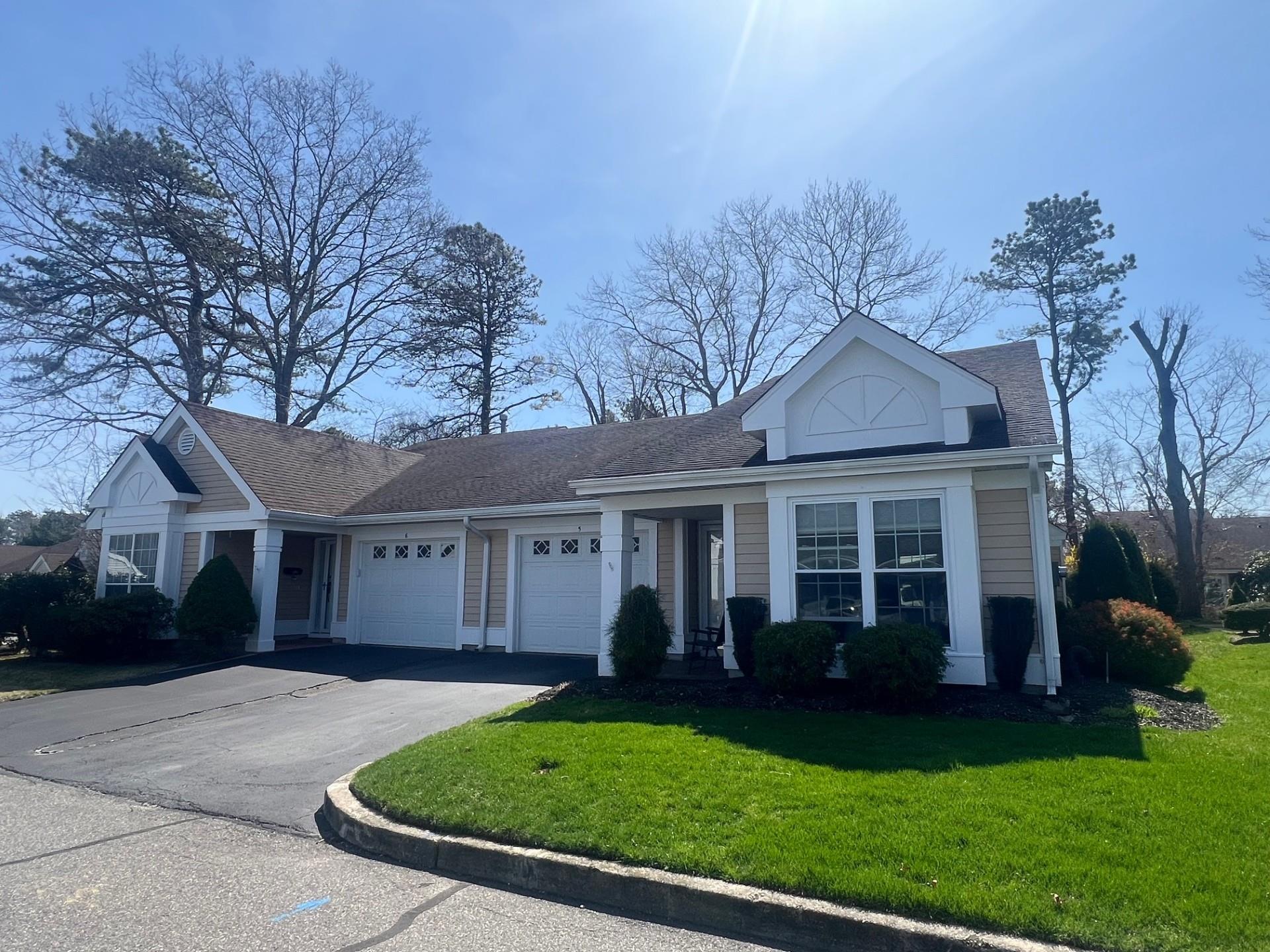5 Wainscott Court Ridge, NY 11961 - Photo 1 of 1 View of front facade with aphalt driveway, an attached garage, a shingled roof, and a front yard