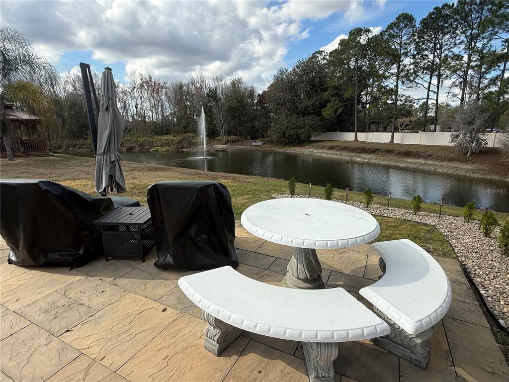 1141 Motorcoach Drive Polk City, FL 33868 - Photo 3 of 4 a view of a balcony with table and chairs