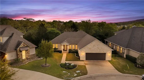 an aerial view of a house with outdoor space