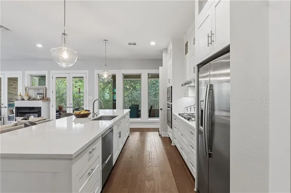 a kitchen with granite countertop a stove and a refrigerator