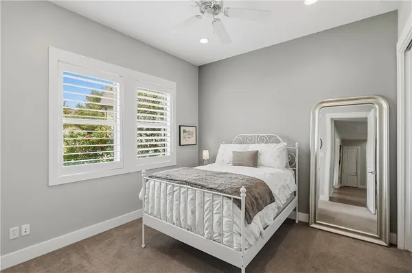 a bedroom with a large bed and a window