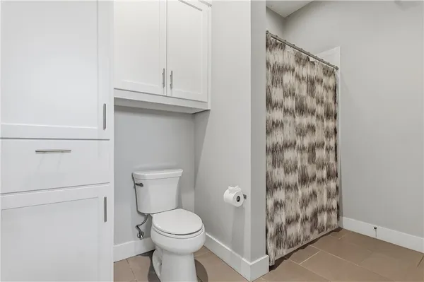 a living room with furniture a fireplace and a floor to ceiling window