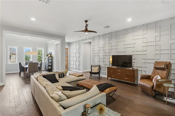a living room with furniture and wooden floor