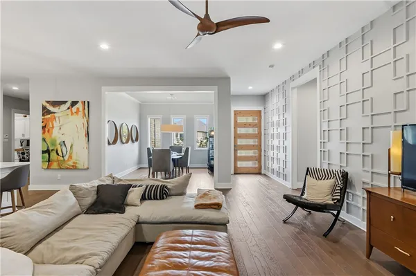 a living room with furniture and a wooden floor