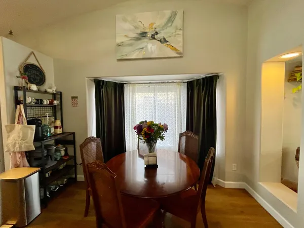 a dining room with furniture and window