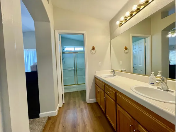 a spacious bathroom with a double vanity sink and a mirror