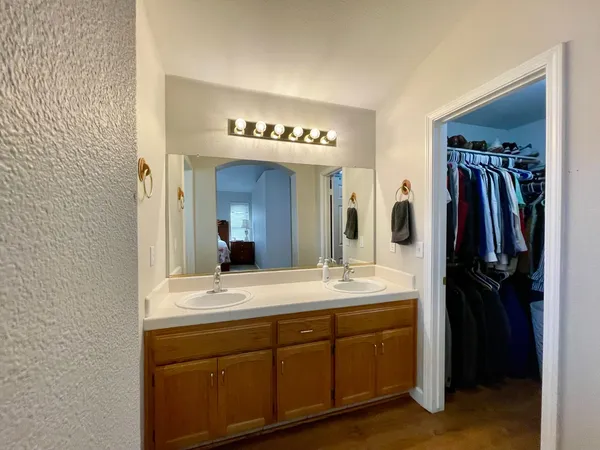 a bathroom with a double vanity sink and a mirror