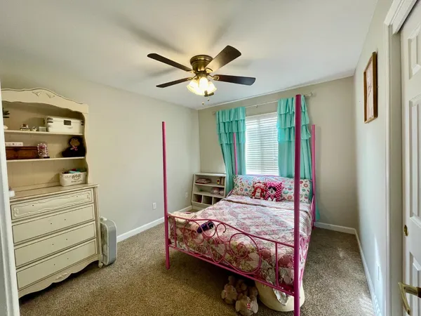 a bedroom with a bed and a dresser