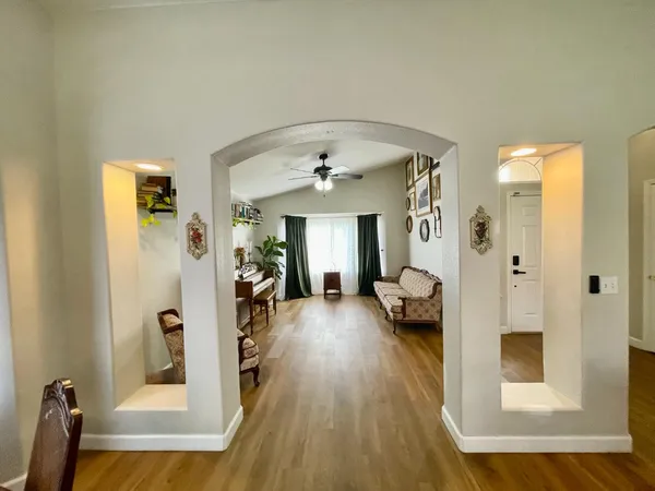 a living room with furniture and a wooden floor