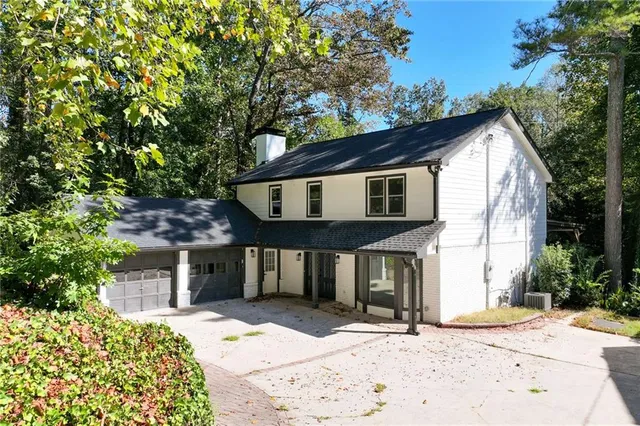 a front view of a house with a garden