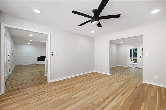 a view of a big room with wooden floor and a ceiling fan