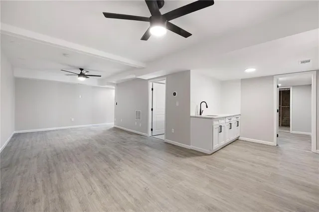 a view of an empty room and kitchen view