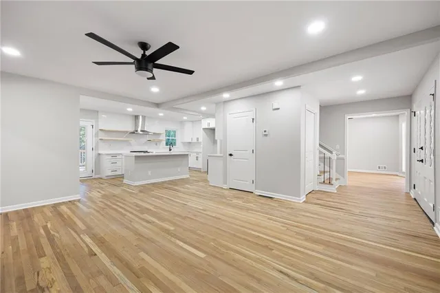 a view of a kitchen with a sink and wooden floor