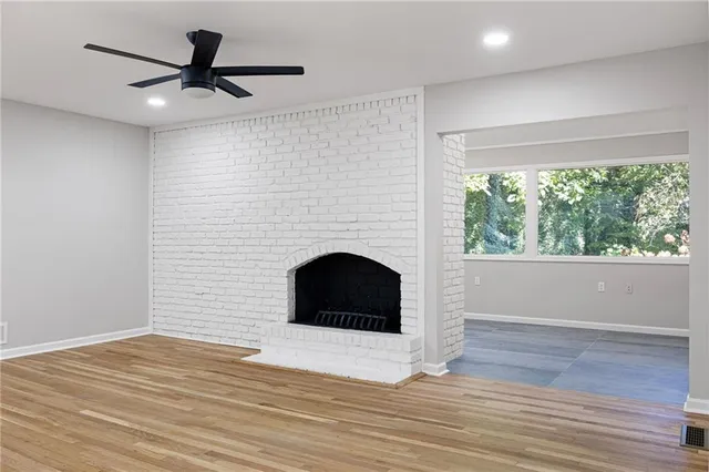 a living room with a fireplace and a floor to ceiling window