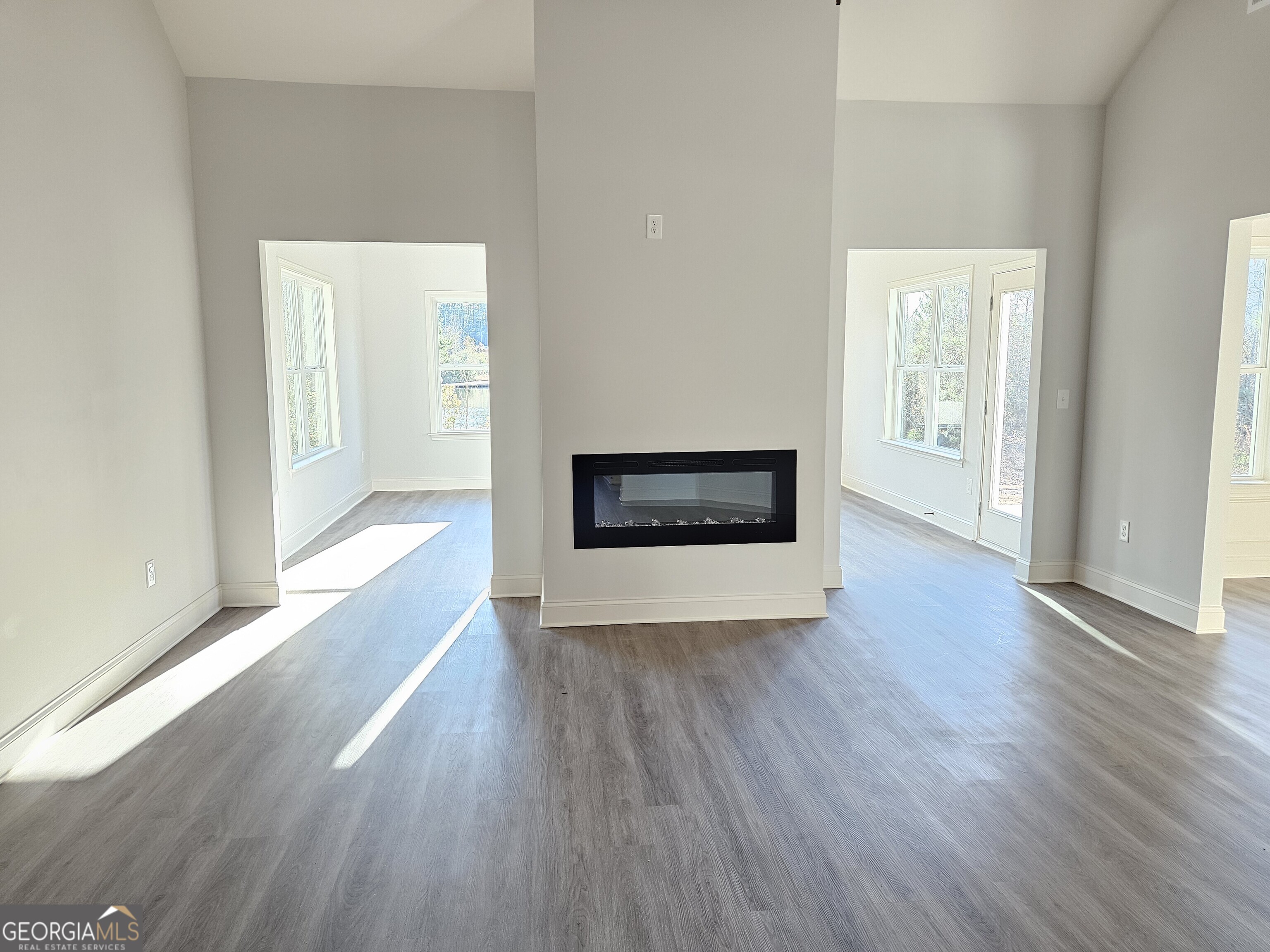 208 Trellis Walk Macon, GA 31220 - Photo 18 of 30 a view of an empty room with wooden floor and a fireplace