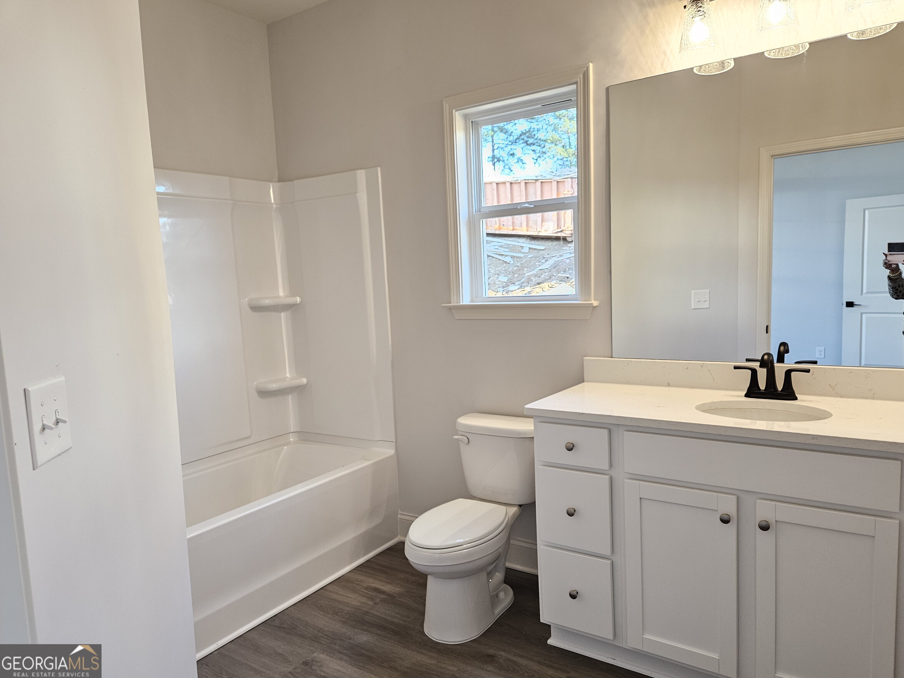 208 Trellis Walk Macon, GA 31220 - Photo 26 of 30 a bathroom with a toilet a sink a mirror and a bathtub