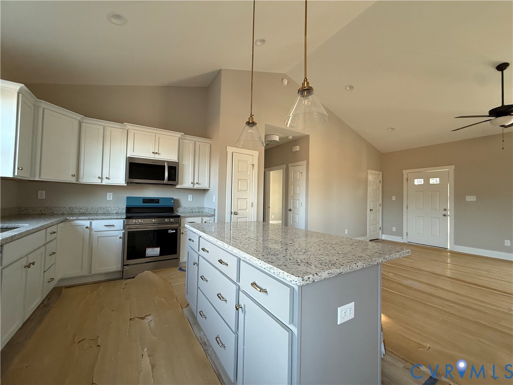 4646 Old Stage Road Lawrenceville, VA 23868 - Photo 18 of 19 a kitchen with stainless steel appliances granite countertop a sink stove and refrigerator