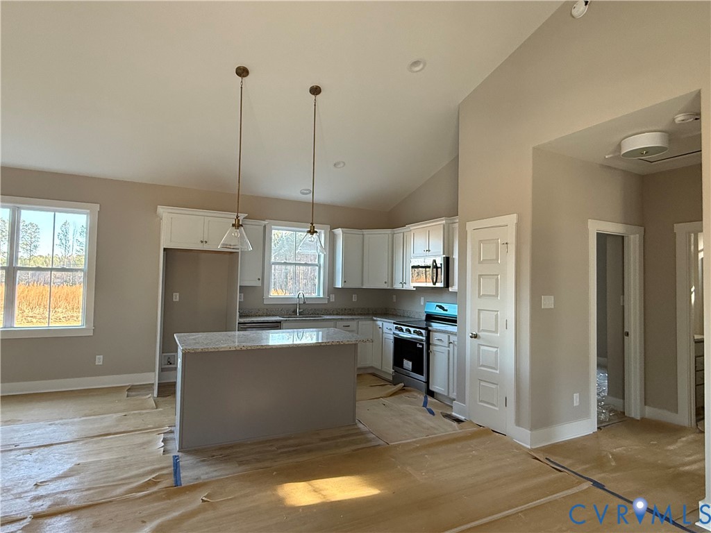 4646 Old Stage Road Lawrenceville, VA 23868 - Photo 3 of 19 a kitchen with kitchen island a counter top space appliances and a window