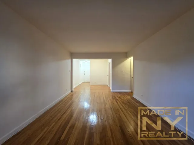 a view of an empty room and wooden floor