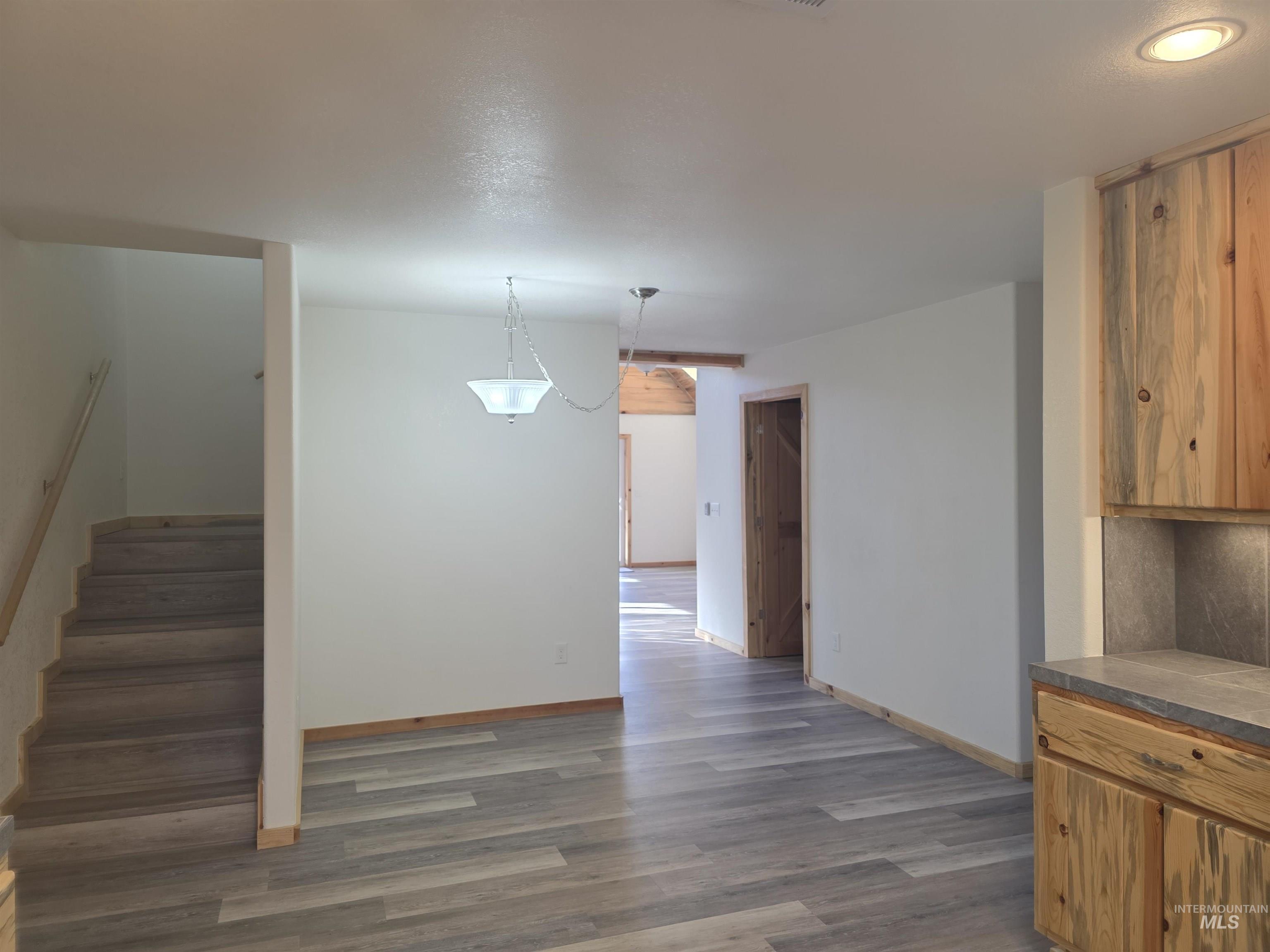 4157 Highway 12 Kamiah, ID 83536 - Photo 14 of 40 Kitchen featuring dark wood finished floors, hanging light fixtures, wood finish cabinetry, and tile countertops