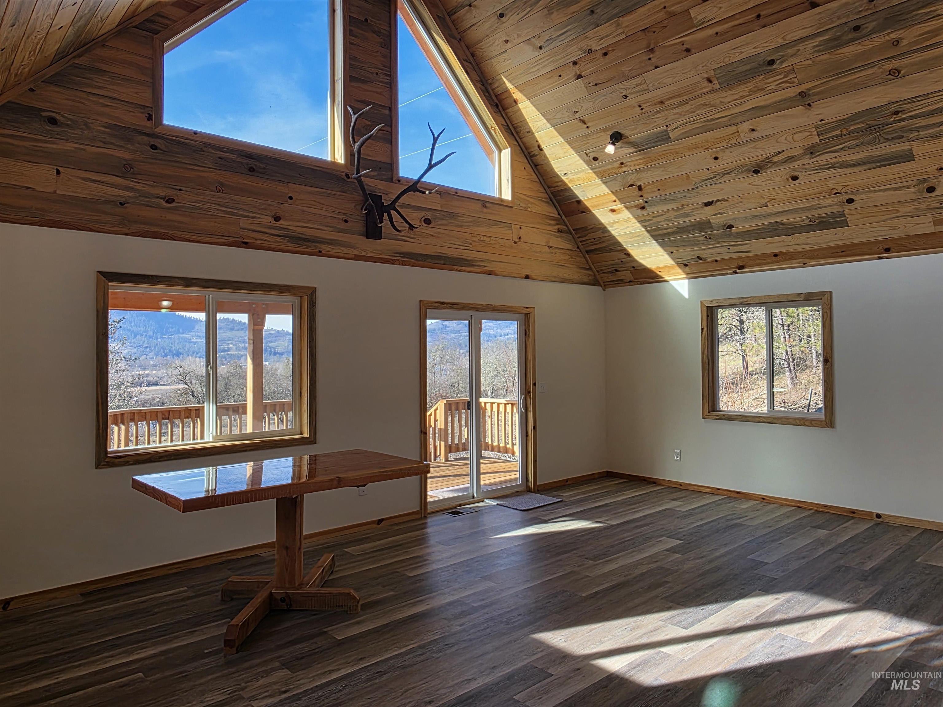 4157 Highway 12 Kamiah, ID 83536 - Photo 16 of 40 Spare room with a vaulted wood ceiling, dark wood-style floors, and healthy amount of natural light
