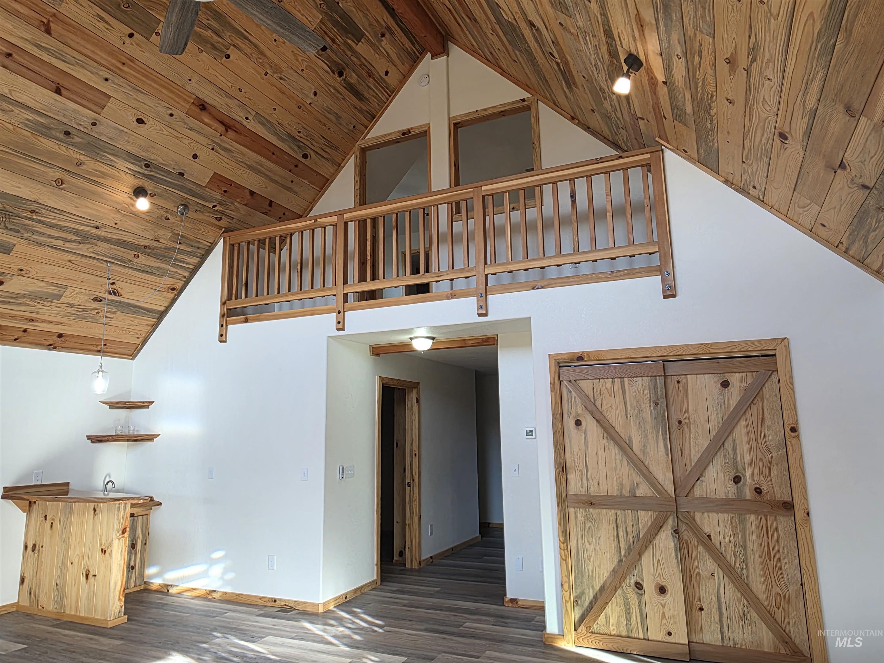 4157 Highway 12 Kamiah, ID 83536 - Photo 20 of 40 Stairway featuring a high wood ceiling, bar with sink, and wood finished floors