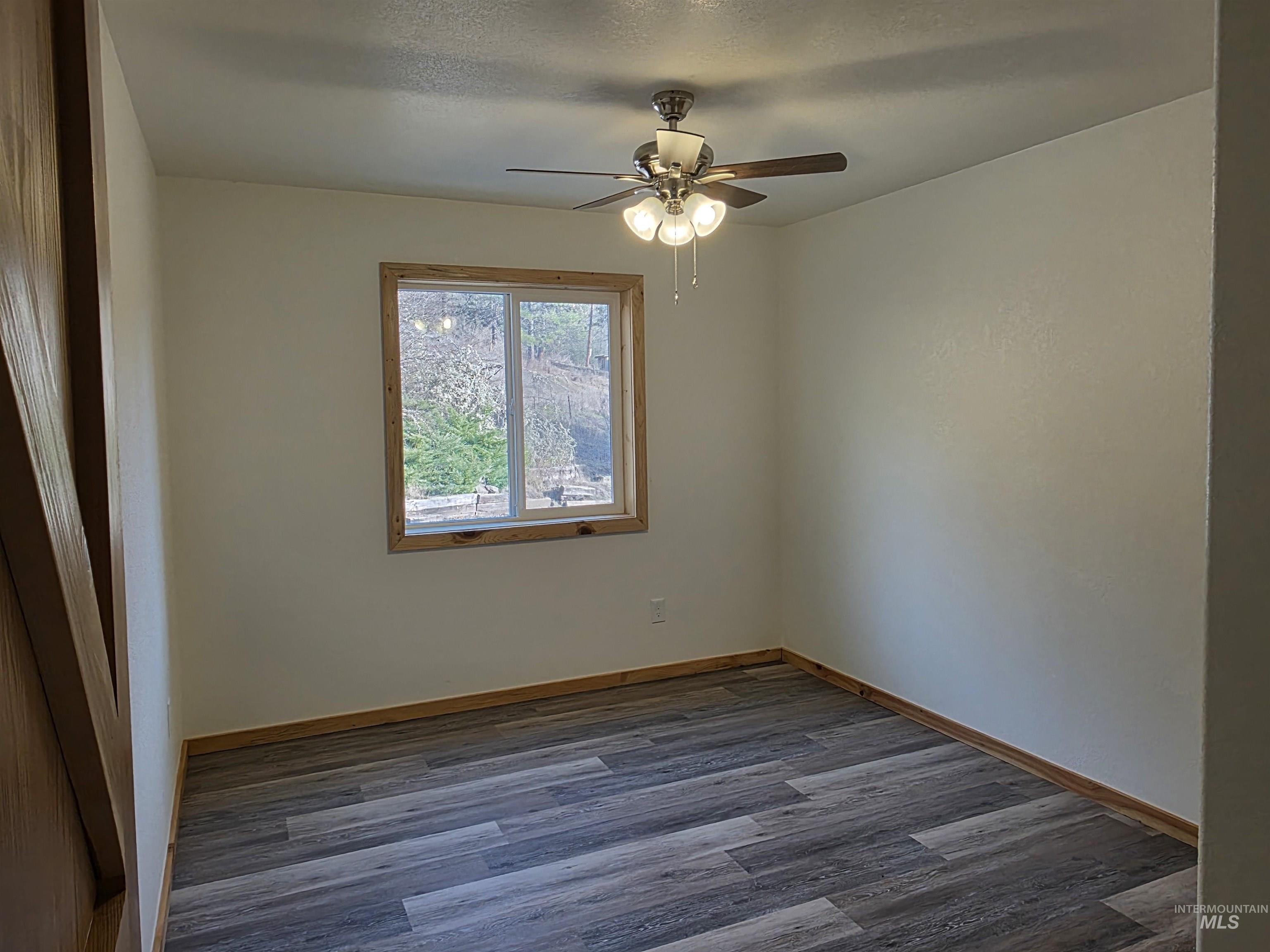 4157 Highway 12 Kamiah, ID 83536 - Photo 25 of 40 Spare room with dark wood finished floors and ceiling fan