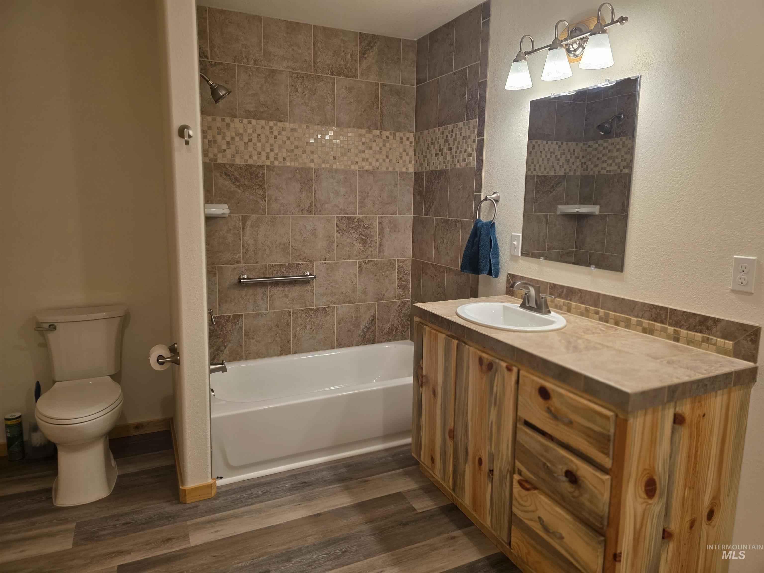 4157 Highway 12 Kamiah, ID 83536 - Photo 27 of 40 Full bathroom with vanity, shower / bath combination, and dark wood-style floors