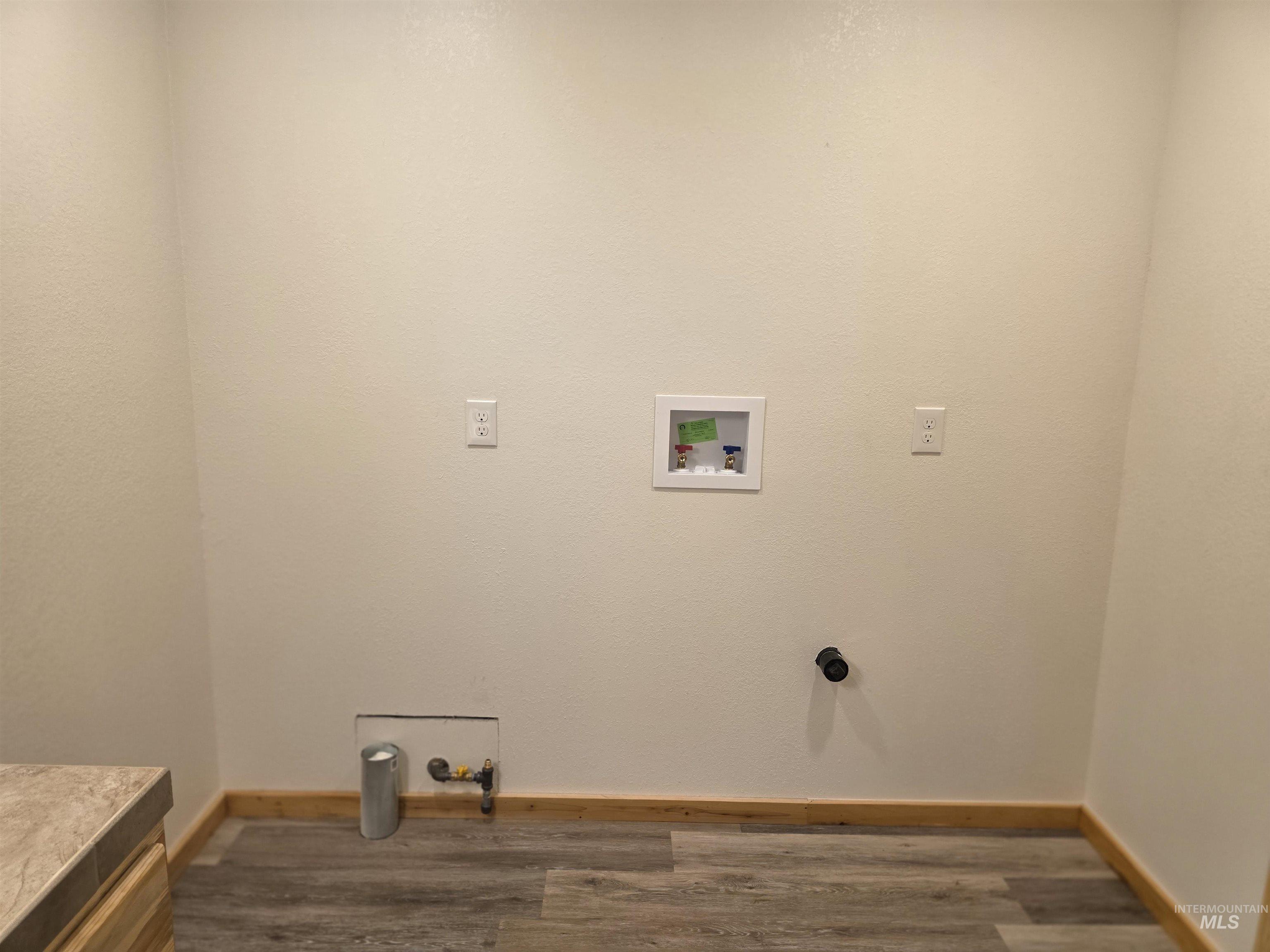 4157 Highway 12 Kamiah, ID 83536 - Photo 29 of 40 Laundry area with dark wood-style floors and hookup for a washing machine