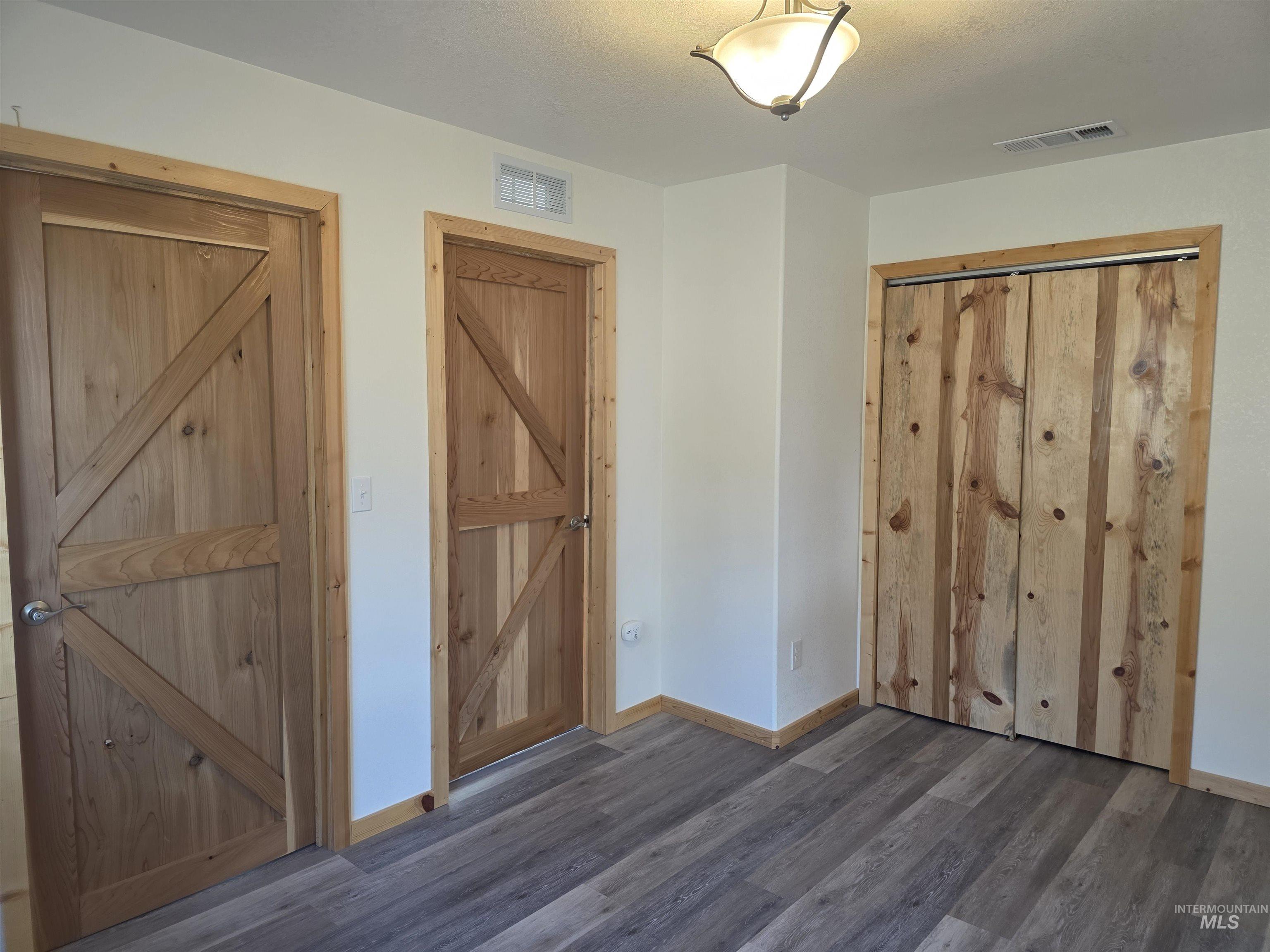 4157 Highway 12 Kamiah, ID 83536 - Photo 30 of 40 Unfurnished bedroom featuring dark wood finished floors and baseboards