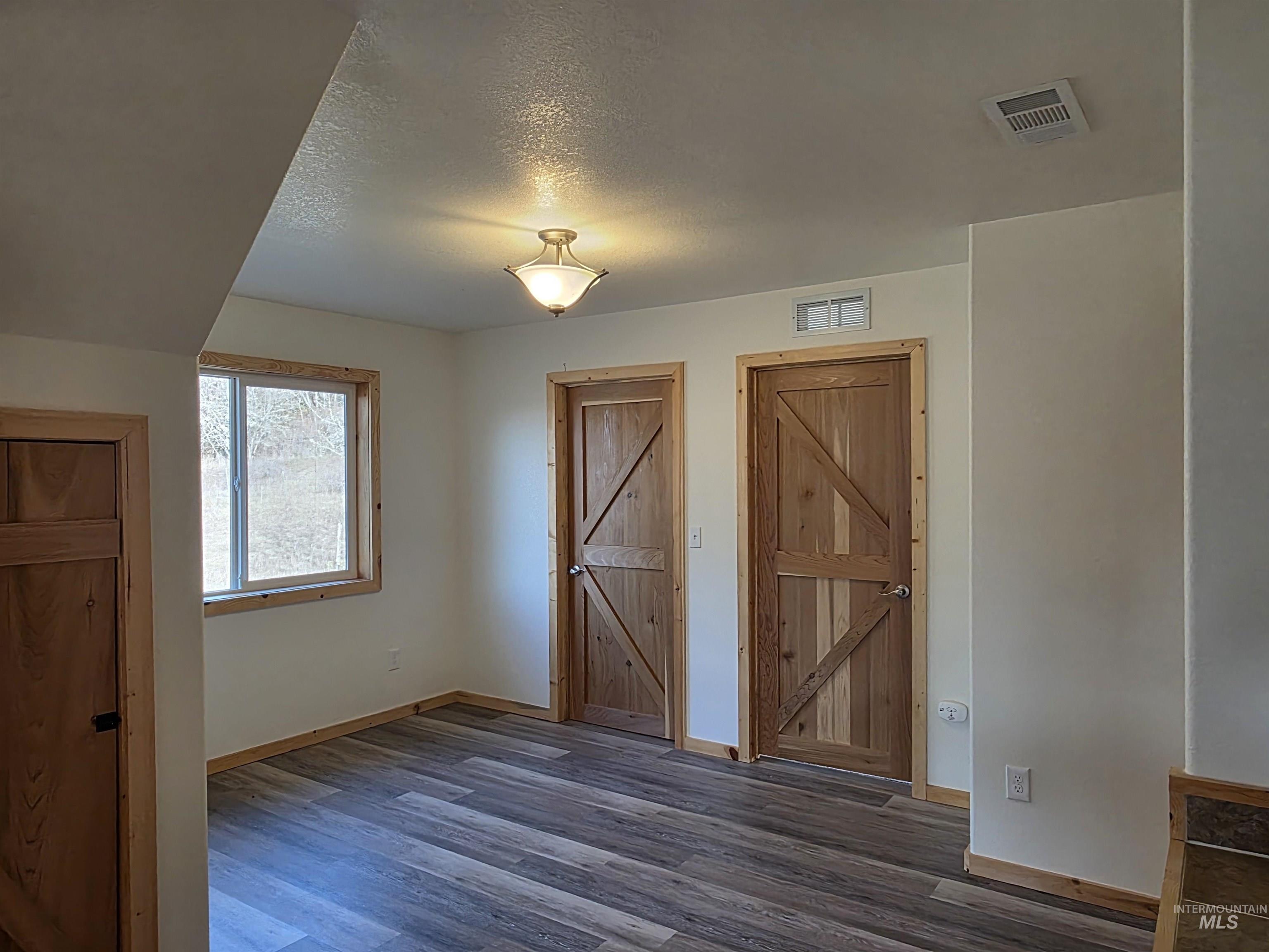 4157 Highway 12 Kamiah, ID 83536 - Photo 31 of 40 Unfurnished dining area featuring a textured ceiling and wood finished floors