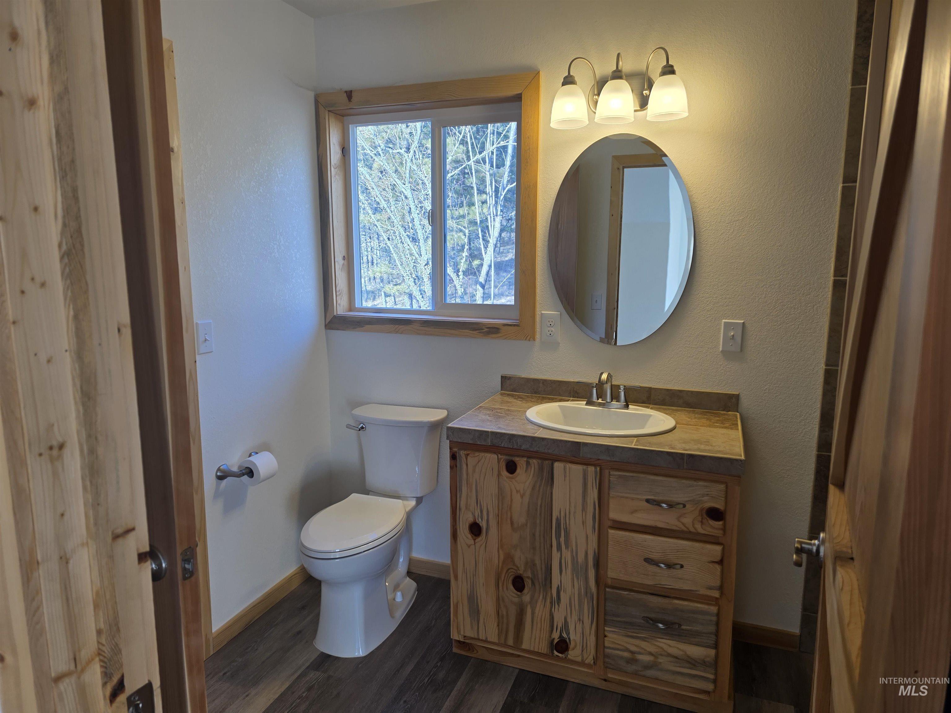 4157 Highway 12 Kamiah, ID 83536 - Photo 35 of 40 Bathroom with vanity, dark wood finished floors, and a textured wall