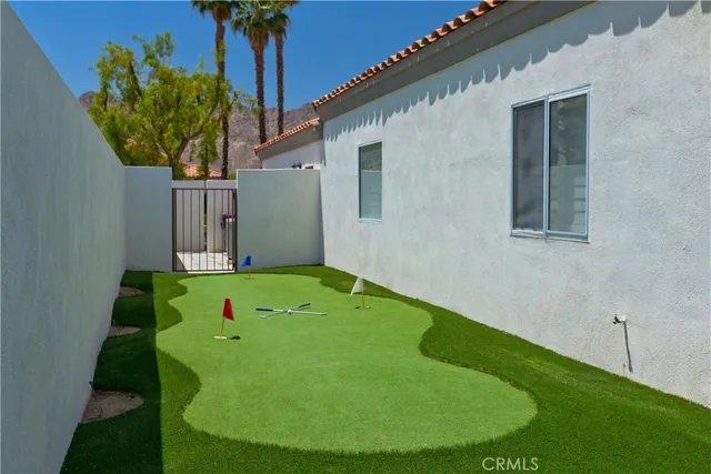 a backyard of a house with plants and a patio