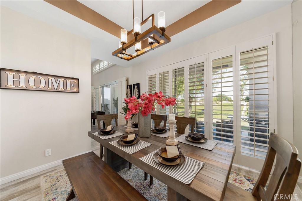 56980 Merion La Quinta, CA 92253 - Photo 20 of 51 a view of a dining room with furniture window and wooden floor