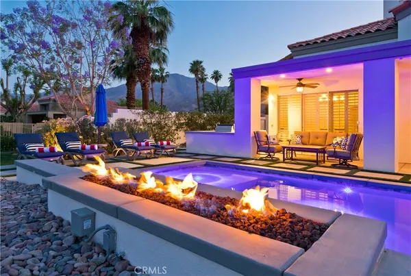 a view of a pool with outdoor seating