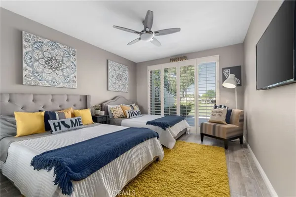 a bedroom with bed and glass window