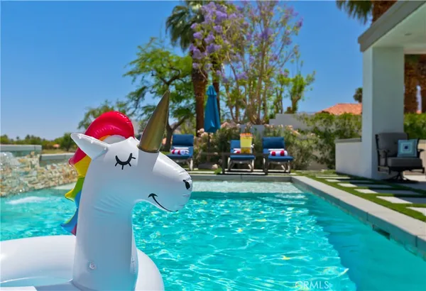 a swimming pool with outdoor seating and yard