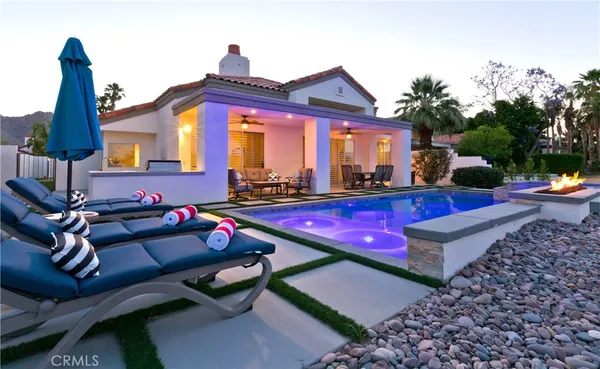 a view of a house with swimming pool and sitting area