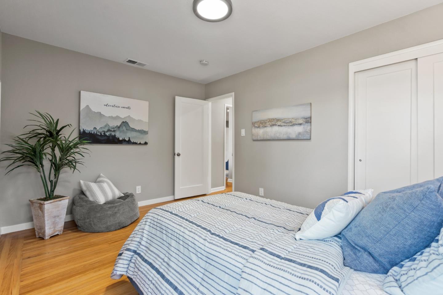 762 Armanini Avenue Santa Clara, CA 95050 - Photo 18 of 43 a bedroom with a large bed and a potted plant